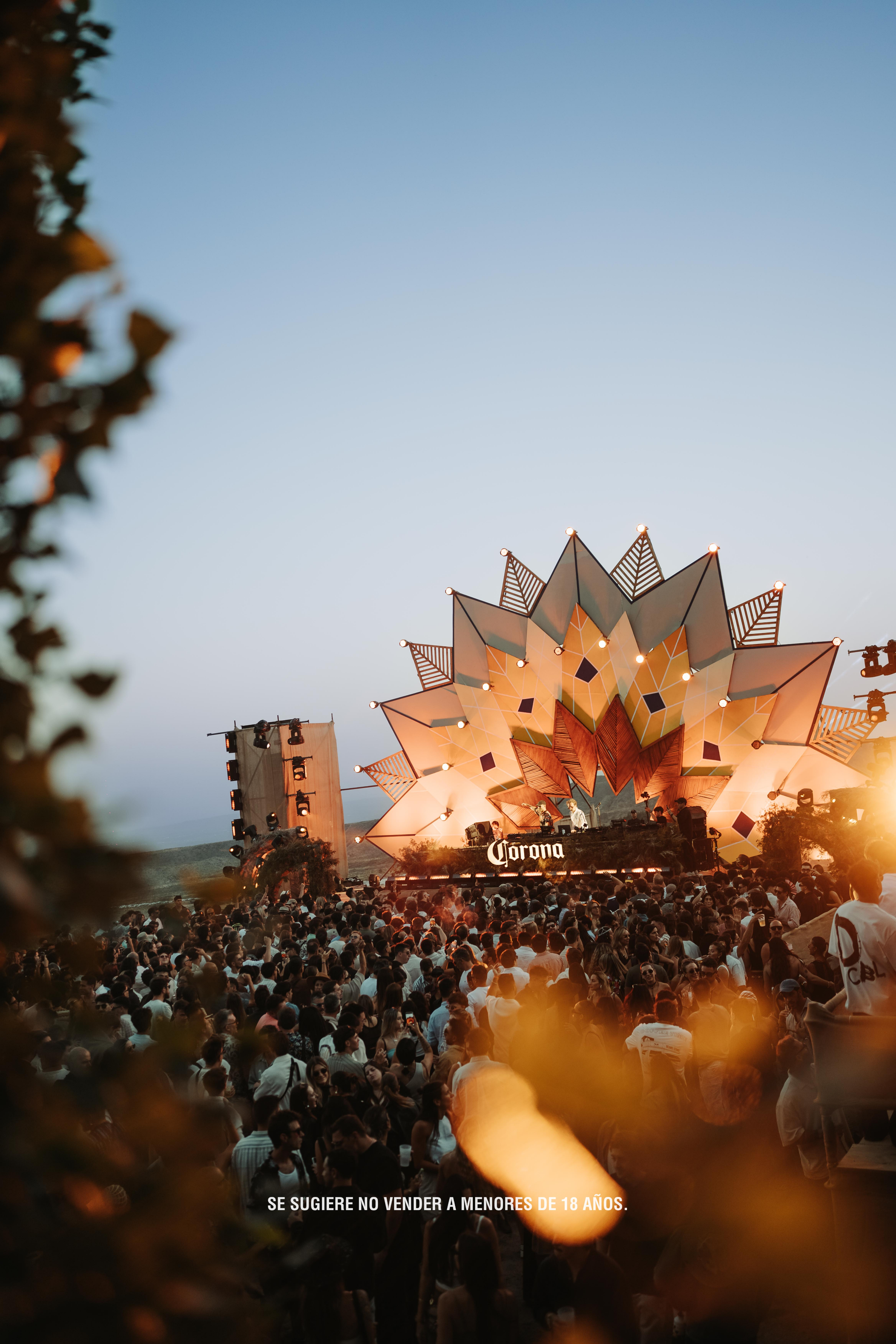 Black and white portrait of a dance instructor posing in front of a dark background.