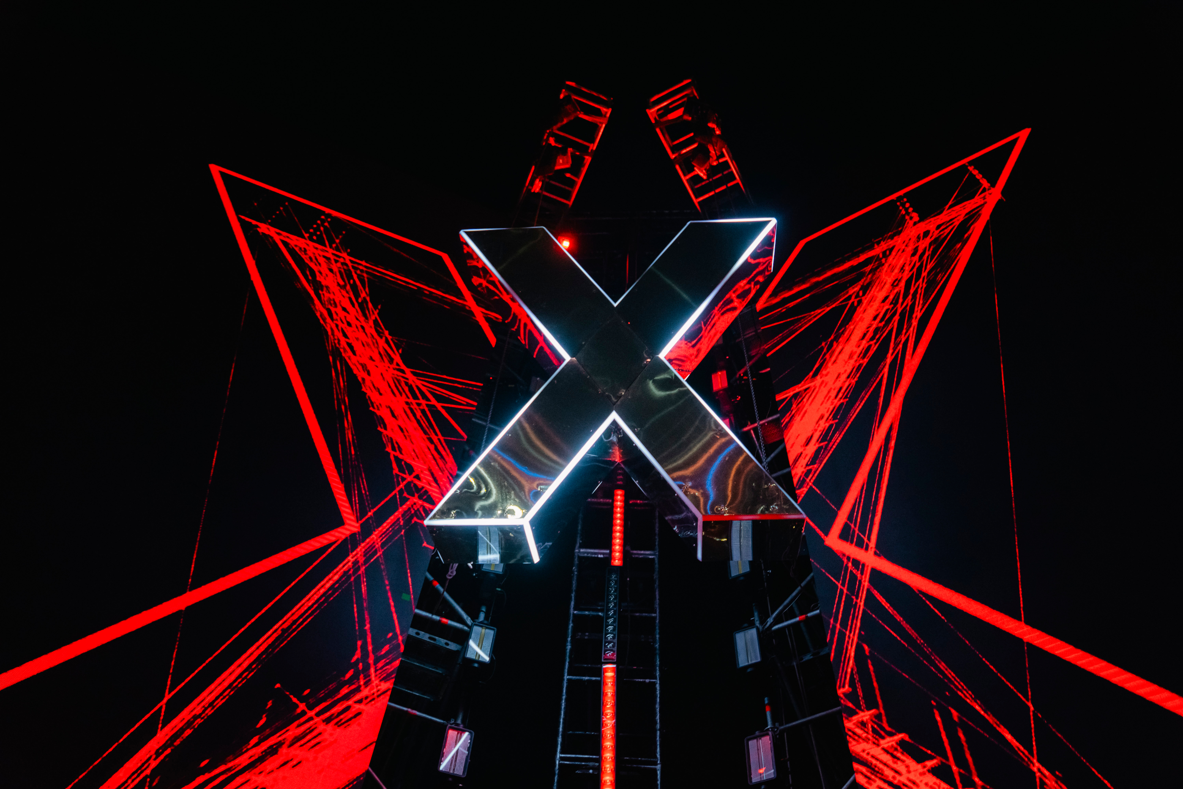 Black and white portrait of a dance instructor posing in front of a dark background.