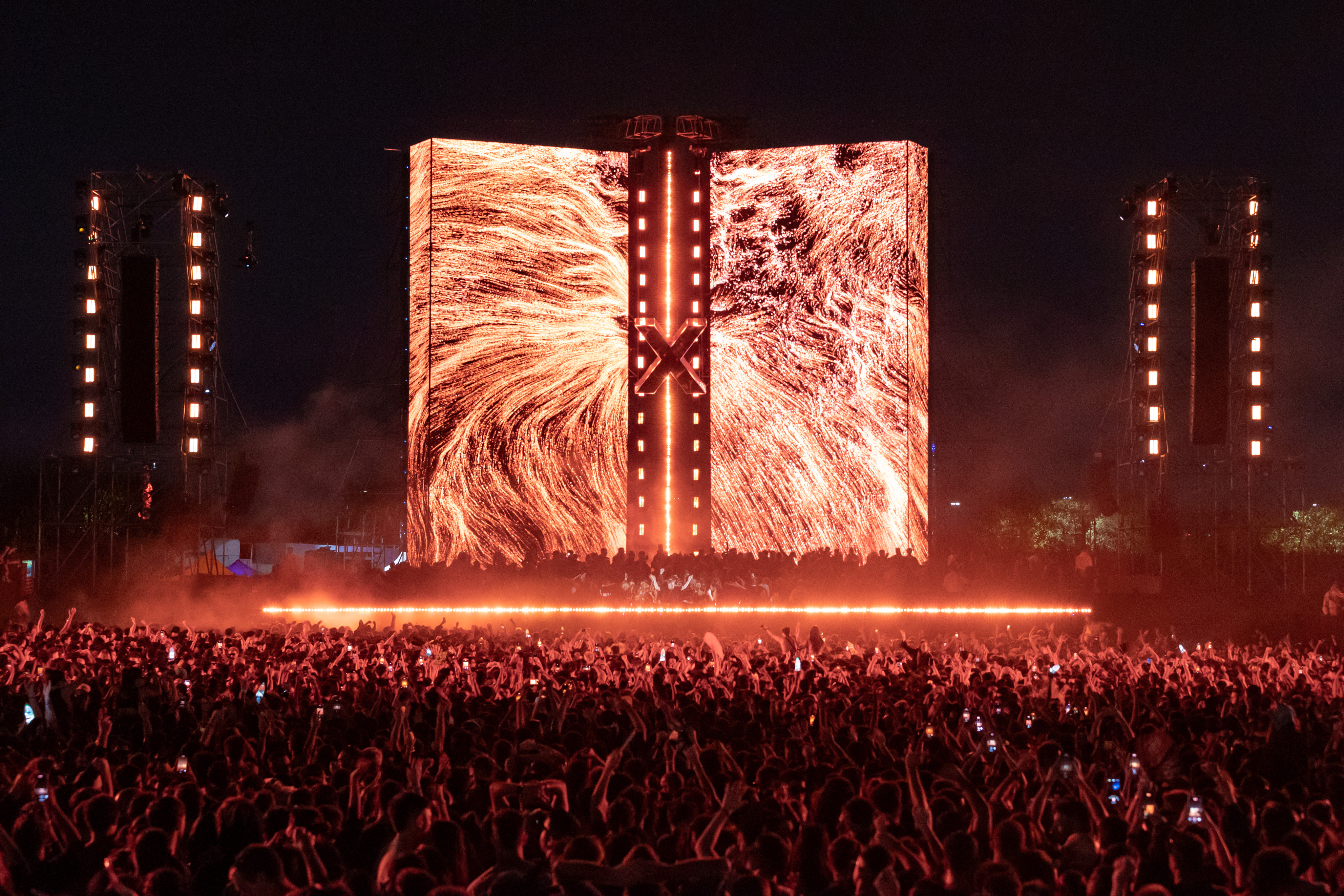 Black and white photo of a women performing modern dance on a dark background.